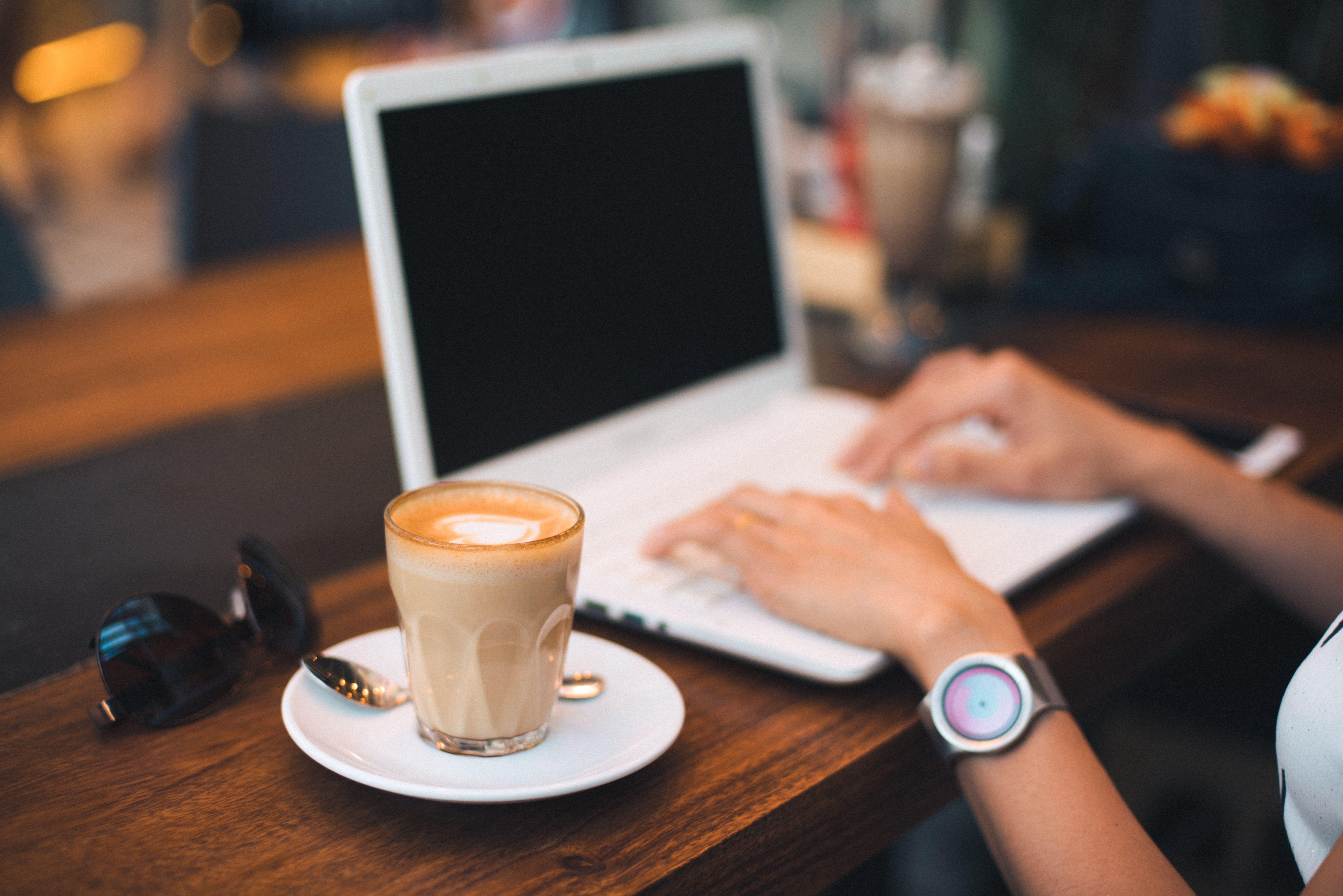 Picture of a laptop user in a coffee shop.